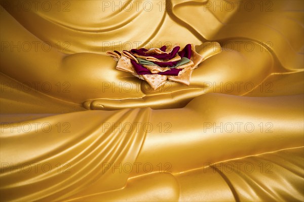 Detail of Buddha statue with offering in palm of hands, Gangaramaya Temple, Colombo, Sri Lanka,