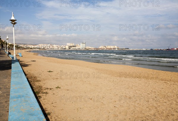 Sandy beach with view to historic walled fort of Melilla la Vieja, Melilla autonomous city state