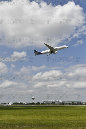 Lufthansa Airbus A350-900 taking off on runway south with tower, Munich Airport, Upper Bavaria,