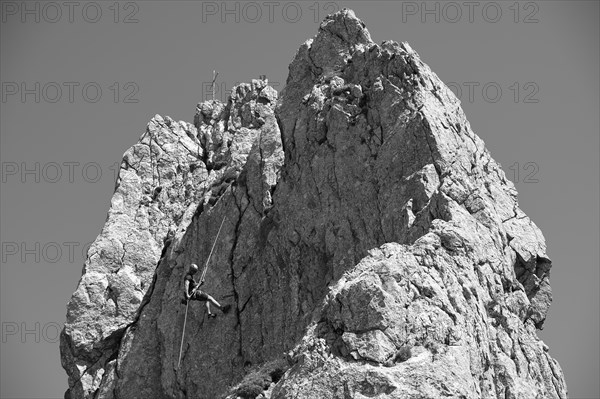 Climber abseiling on the Rosssteinnadel, mountaineering village Kreuth, Mangfall mountains,