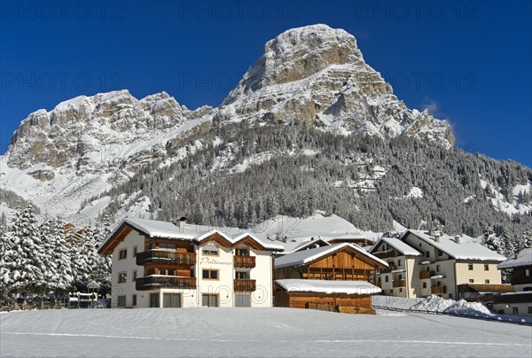 The snow-covered hamlet of Colfosco, Colfosco, at the foot of the Sassongher peak, Colfosco,