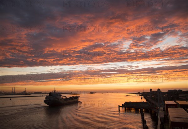Sunset orange glow landscape clouds water, North Sea shipping, Port of Rotterdam, Hook of Holland,
