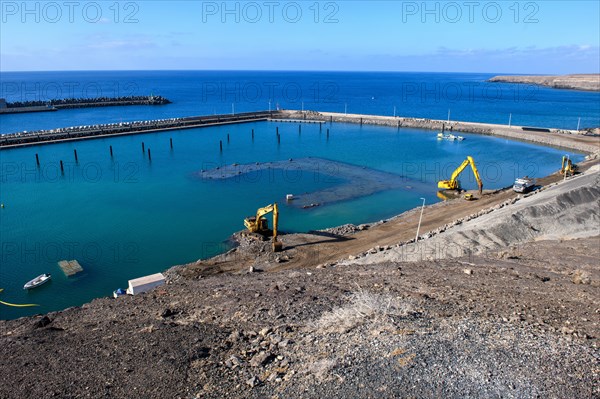 View of two excavators dredging harbour basin new marina harbour for pleasure boats yachts yachts