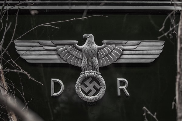 An eagle emblem with spread wings and a swastika, symbol from the time of the Second World War,