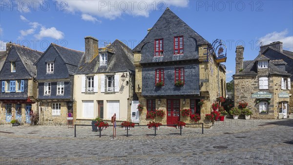 Rue du General de Gaulle in the old town centre of Le Faou with slate-roofed granite houses from