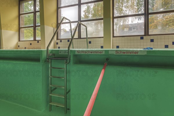 Abandoned swimming pool with signs for non-swimmers and swimmers' areas, Bad am Park, Lost Place,