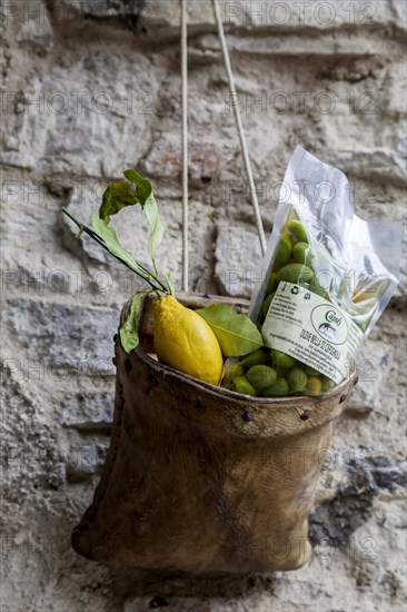House facade with decoration and advertising, leather bag with lemon and olives, Limone sul Garda,