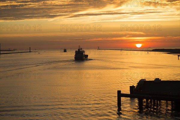 Sunset orange glow landscape clouds water, North Sea shipping, Port of Rotterdam, Hook of Holland,