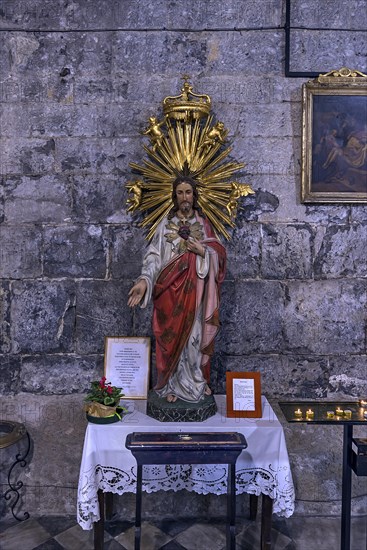 Chistus figure with sacrificial candles in the church of San Donato, 12th century, Via S. Donato,