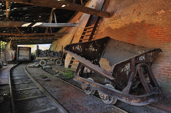 Rusty wagons with load of bricks near ring oven, kiln at brickworks, Boom, Belgium, Europe