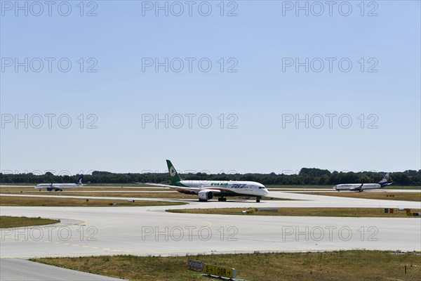 Eva Air Dreamliner, SunExpress and Anadolujet Airlines aircraft taxiing on the taxiways at Runway