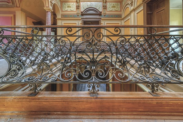 Detailed wrought-iron railing on an elegant staircase with wooden steps, Villa Woodstock, Lost