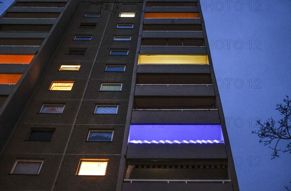 Illuminated flats and balconies in a tower block in Gropiusstadt. The rise in rents in German