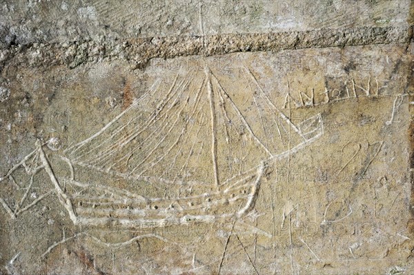 Old graffiti of galleon sailing ship carved on rampart wall of the citadel at Brouage,