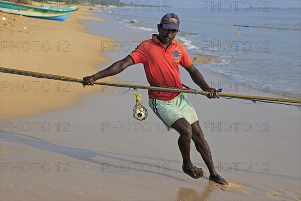 Traditional fishing hauling nets Nilavelli beach, near Trincomalee, Eastern province, Sri Lanka,
