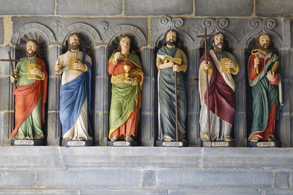 Six statues of saints in a restored version in front of the entrance to the Saint-Sauveur church on