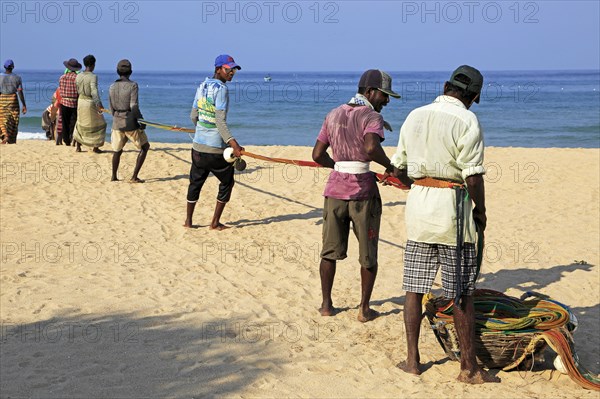 Traditional fishing hauling nets Nilavelli beach, near Trincomalee, Eastern province, Sri Lanka,