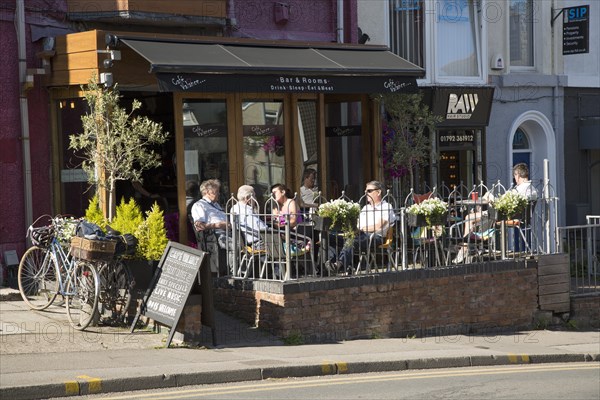 People sitting outside cafe bar, Oystermouth, Mumbles, Gower peninsula, near Swansea, South Wales,