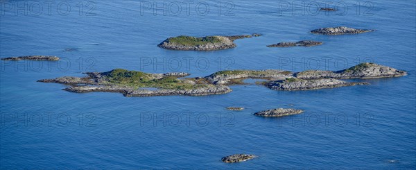 Rocky islands in the blue sea, sea with archipelago islands, Ulvagsundet, Vesteralen, Norway,