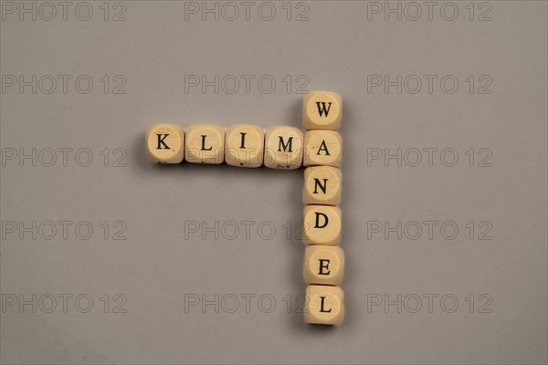 Cubes with letters form the word climate change, light background, top view, studio shot, Germany,