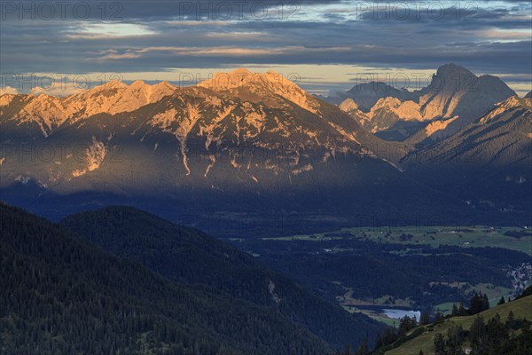 Distant view of steep mountains in the evening light, clouds, autumn, view from Wank to Karwendel