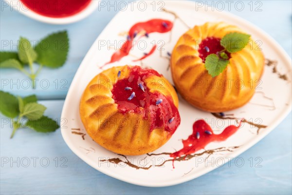 Semolina cheesecake with strawberry jam, lavender, cup of coffee on blue wooden background. side