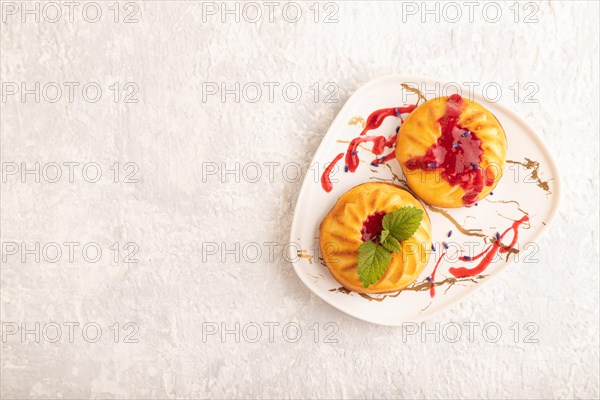 Semolina cheesecake with strawberry jam, lavender on gray concrete background. top view, flat lay,