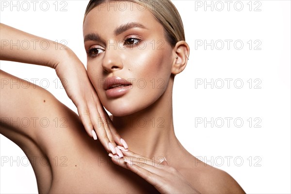 Beauty portrait of model with natural make-up. Fashion shiny highlighter on skin, sexy gloss lips
