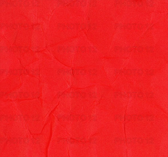 Crumpled red paper texture background