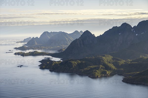 View of the coast in Ulvagsundet fjord and mountains in the evening light, Hurtigruten cruise ship