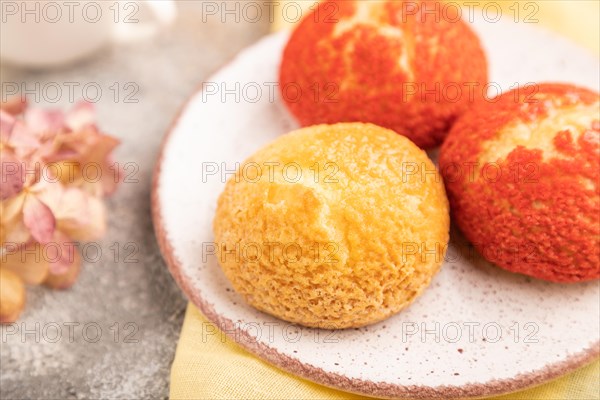 Traditional french custard dessert shu cake and cup of green tea on brown concrete background and
