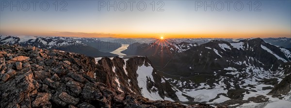 Panorama, view of mountains and fjord Faleidfjorden, sun star at sunset, summit of Skala, Loen,