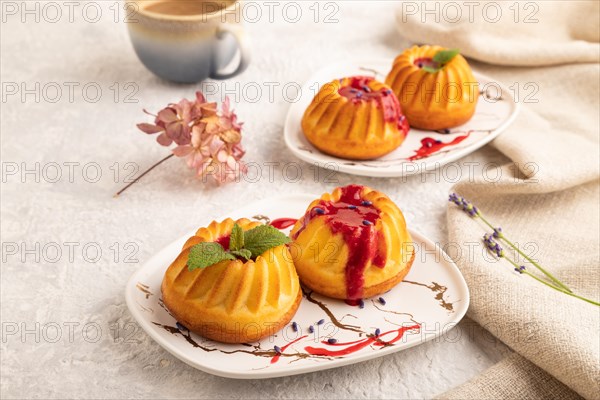 Semolina cheesecake with strawberry jam, lavender, cup of coffee on gray concrete background and