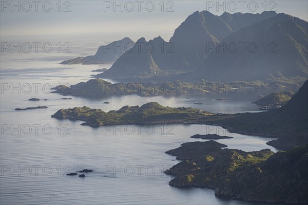 View of the coast in Ulvagsundet fjord and mountains in the evening light, Hurtigruten cruise ship