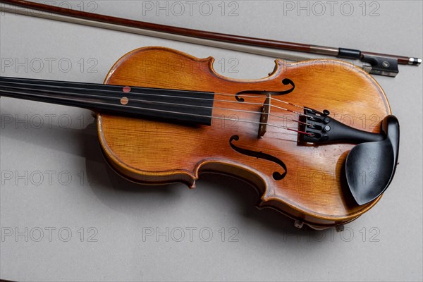 Half viola, with bow in front of a white background, studio photograph, Germany, Europe