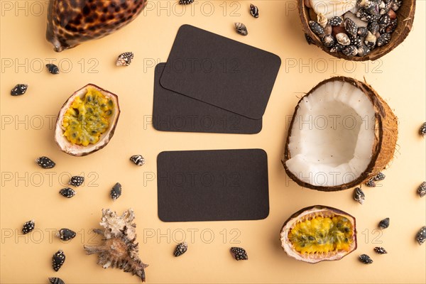 Brown paper business card with coconut, passion fruit, seashells, on orange pastel background. Top