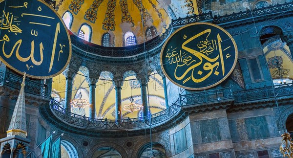 Medallions with Arabic script hanging on wall inside Hagia Sophia Mosque in Istanbul, Turkiye