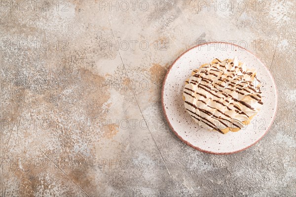 Tartlets with meringue cream on brown concrete background. top view, flat lay, copy space.