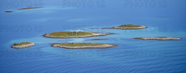 Rocky islands in the evening light, sea with archipelago islands, Ulvagsundet, Vesteralen, Norway,
