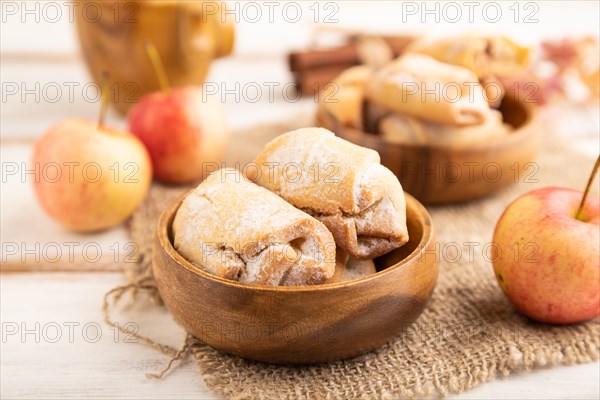 Homemade sweet cookie with apple jam and cup of coffee on white wooden background and linen textile