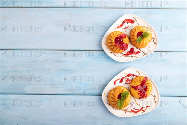 Semolina cheesecake with strawberry jam, lavender, on blue wooden background. top view, flat lay,