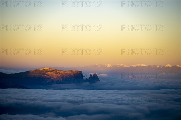 Sunrise over a sea of fog with the peaks of the Sella massif in the background, Corvara, Dolomites,