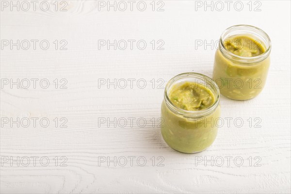 Baby puree with vegetable mix, broccoli, tomatoes, cucumber, avocado infant formula in glass jar on