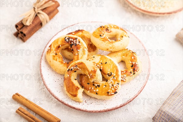 Homemade asian salted cookies, cup of green tea on gray concrete background and linen textile. side