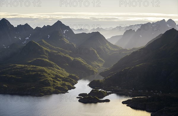 Mountains and fjord landscape with atmospheric evening light, Ulvagfjorden fjord and mountains,