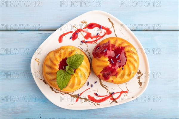 Semolina cheesecake with strawberry jam, lavender, on blue wooden background. top view, flat lay,