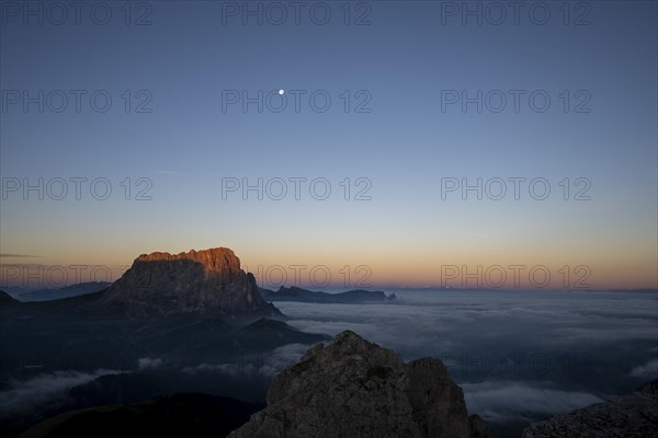 Sunrise over a sea of fog with the peaks of the Sella massif in the background, Corvara, Dolomites,