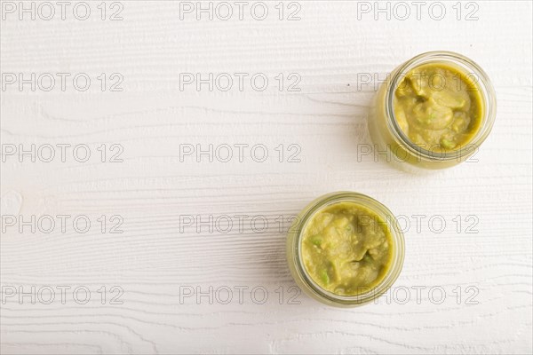 Baby puree with vegetable mix, broccoli, tomatoes, cucumber, avocado infant formula in glass jar on