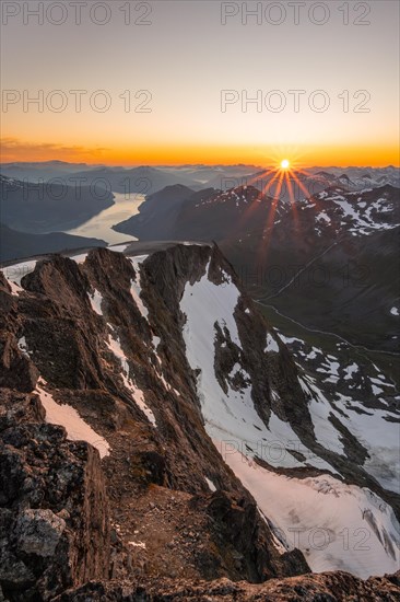 View of mountains and fjord Faleidfjorden, sun star at sunset, summit of Skala, Loen, Norway,