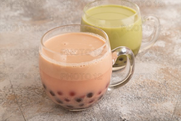 Bubble tea with pistachio and caramel in glass on brown concrete background. Healthy drink concept.